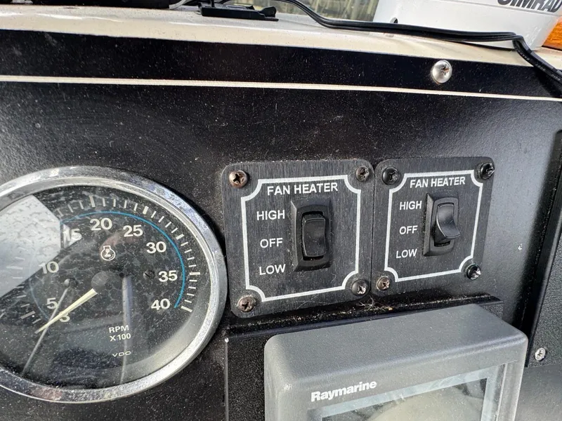 Slide: The Image of Control panel of 1989 Prima 52 Cockpit Motor Yacht with fan heater switches and RPM gauge. - 27
