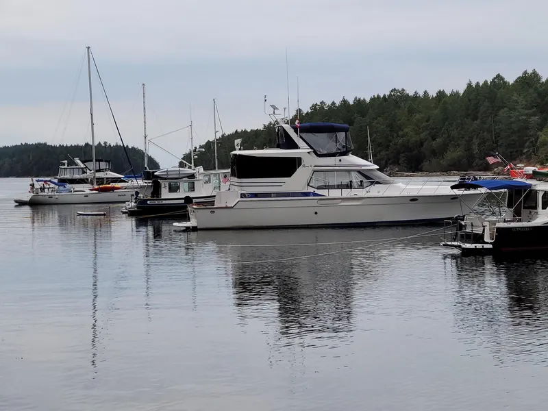 Slide: The Image of 1989 Prima 52 Cockpit Motor Yacht docked in a serene marina setting. - 3