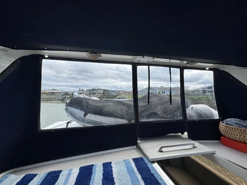Slide: The Image of Interior view of 1989 Prima 52 Cockpit Motor Yacht with marina backdrop. - 32