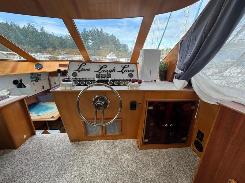 Slide: The Image of Cockpit of 1989 Prima 52 Motor Yacht with steering wheel and "Live Laugh Love" sign. - 35