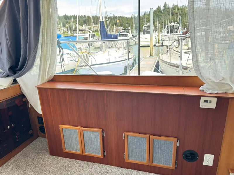Slide: The Image of Interior view of 1989 Prima 52 Cockpit Motor Yacht with marina backdrop. - 39