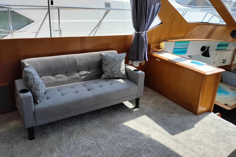 Slide: The Image of Interior of 1989 Prima 52 Cockpit Motor Yacht with gray sofa and wooden accents. - 40
