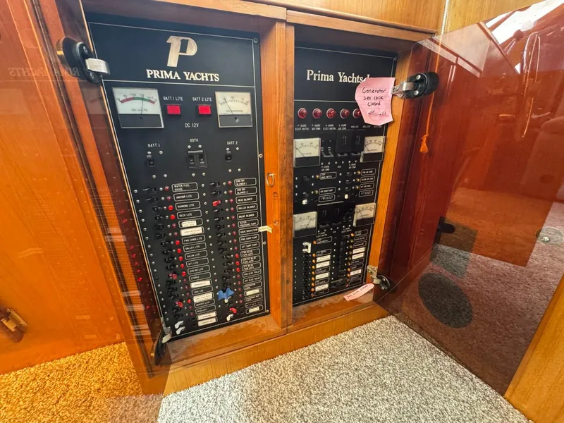 Slide: The Image of Electrical panel of 1989 Prima 52 Cockpit Motor Yacht with control switches and meters. - 44