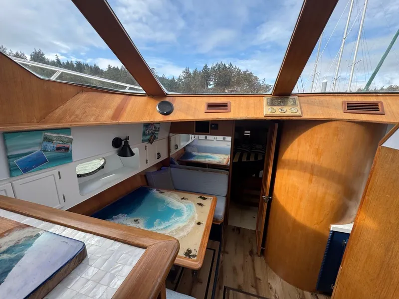 Slide: The Image of 1989 Prima 52 Cockpit Motor Yacht interior with wood finish and scenic artwork. - 45
