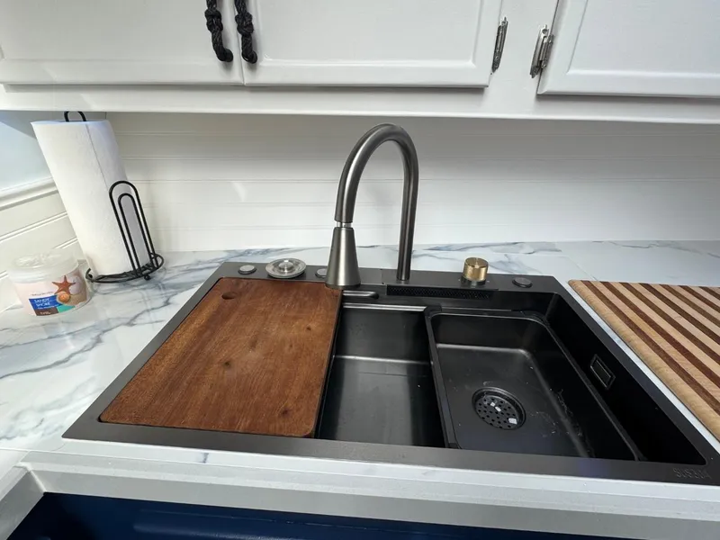 Slide: The Image of Modern kitchen sink with cutting board and faucet on Prima 52 Cockpit Motor Yacht, 1989. - 48
