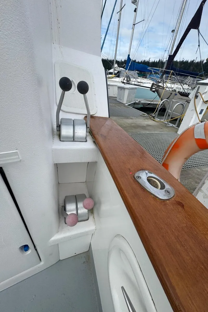 Slide: The Image of 1989 Prima 52 Cockpit Motor Yacht controls and deck view at marina. - 6