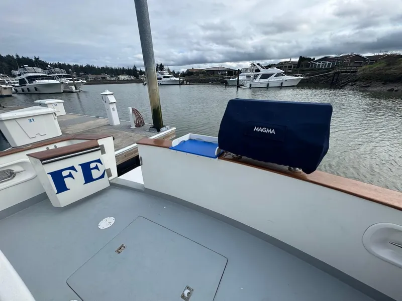Slide: The Image of 1989 Prima 52 Cockpit Motor Yacht docked in a marina with overcast skies. - 8