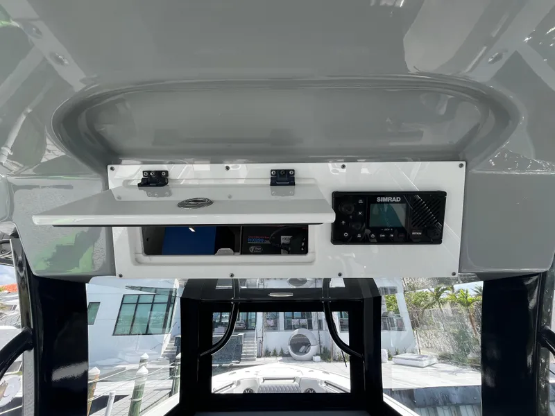 Slide: The Image of 2022 Seapro 320 DLX boat console with open storage and electronic display. - 10