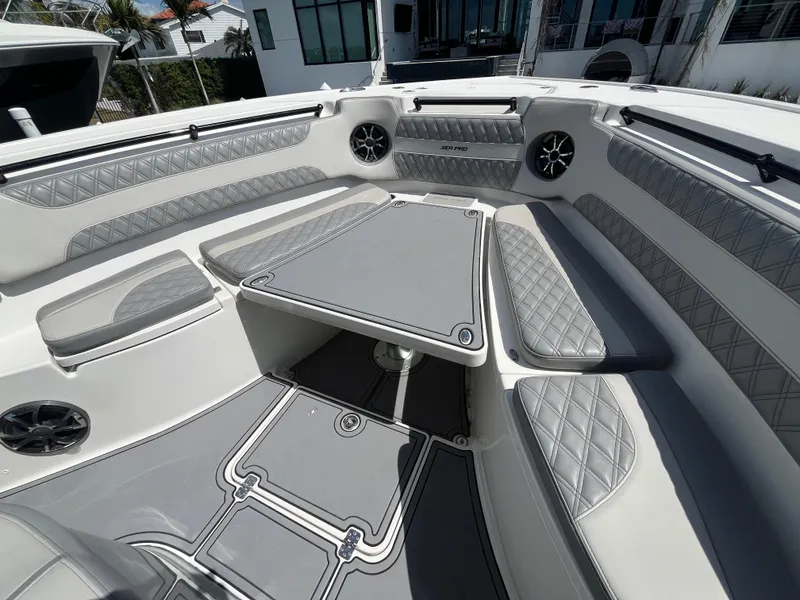 Slide: The Image of 2022 Seapro 320 DLX boat interior with gray seating and table, featuring modern design elements. - 14