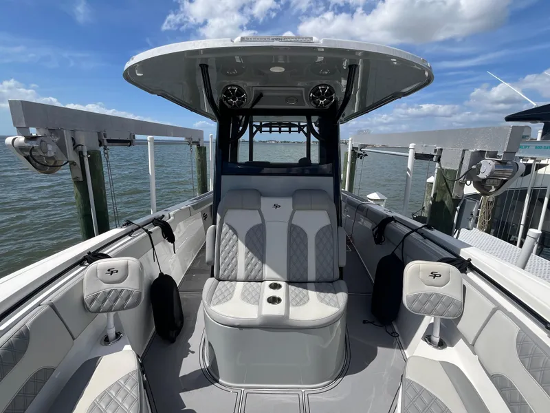 Slide: The Image of 2022 Seapro 320 DLX boat interior with seating, ocean view, and clear sky. - 17