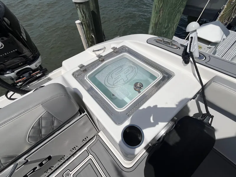 Slide: The Image of 2022 Seapro 320 DLX boat with livewell and seating, docked by water. - 25