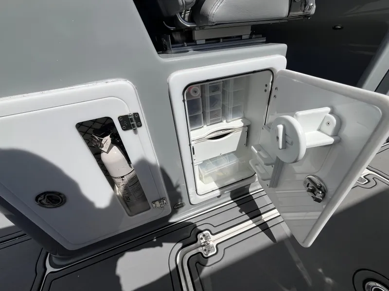 Slide: The Image of 2022 Seapro 320 DLX boat storage compartments with open doors, showcasing interior features. - 27
