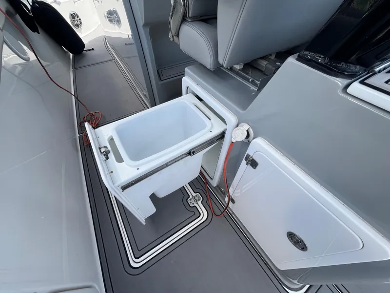 Slide: The Image of 2022 Seapro 320 DLX boat interior with open storage compartment and seating. - 28