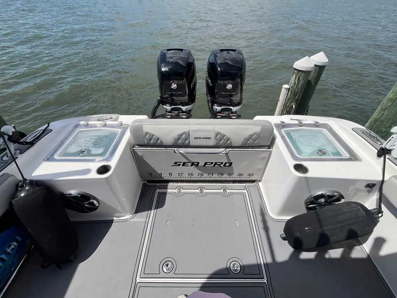 Slide: The Image of 2022 Seapro 320 DLX boat with dual engines docked on water. - 3