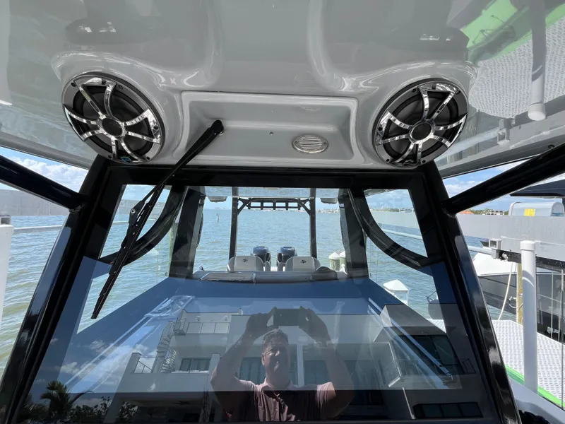 Slide: The Image of 2022 Seapro 320 DLX boat interior with speakers, overlooking water and dock. - 32