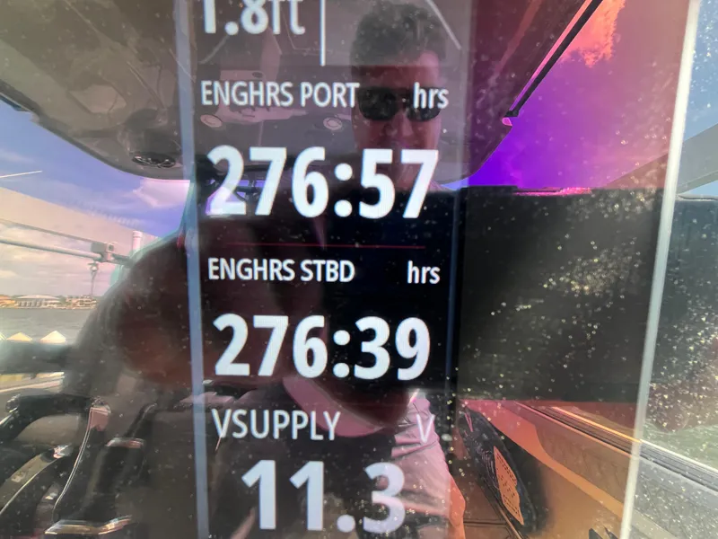 Slide: The Image of Display screen showing engine hours and voltage on a 2022 Seapro 320 DLX boat. - 34