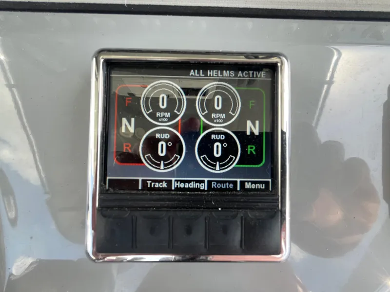 Slide: The Image of Control panel of a 2022 Seapro 320 DLX boat, displaying RPM and rudder settings. - 38