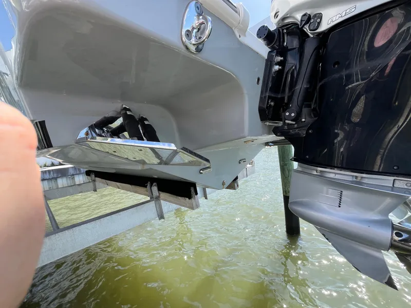 Slide: The Image of 2022 Seapro 320 DLX boat with outboard motor, docked above water. - 42