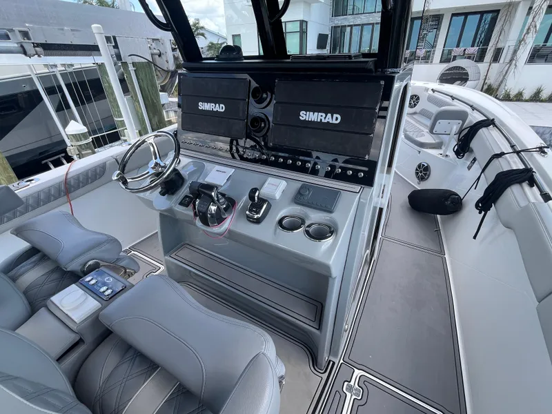 Slide: The Image of 2022 Seapro 320 DLX boat cockpit with Simrad navigation system and modern controls. - 9