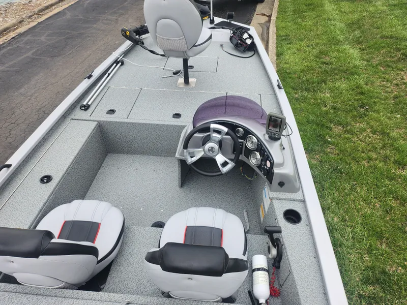 Slide: The Image of 2016 G3 Eagle 166 boat interior with steering wheel, seats, and fishing equipment. - 11