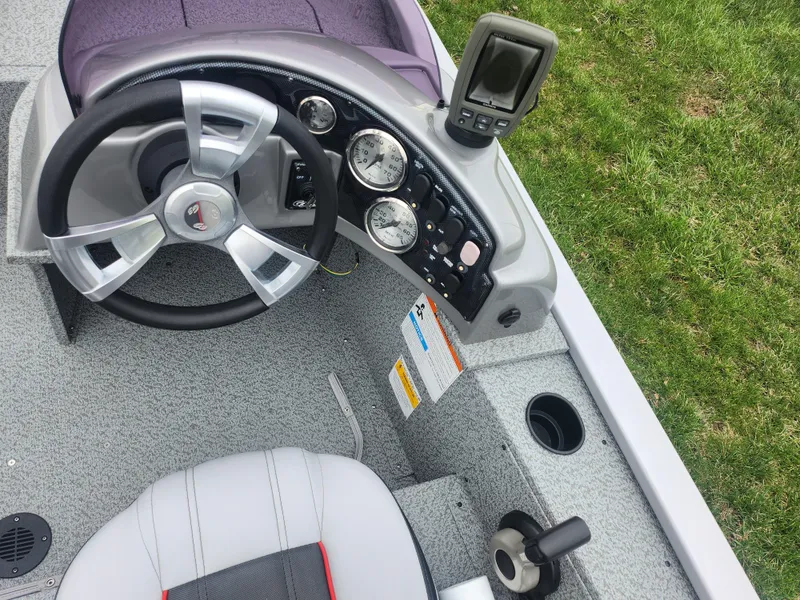 Slide: The Image of 2016 G3 Eagle 166 boat dashboard with steering wheel and gauges. - 12