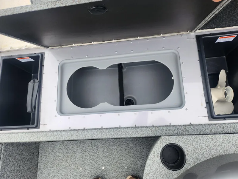 Slide: The Image of 2016 G3 Eagle 166 boat storage compartments with open lids and visible interior. - 15