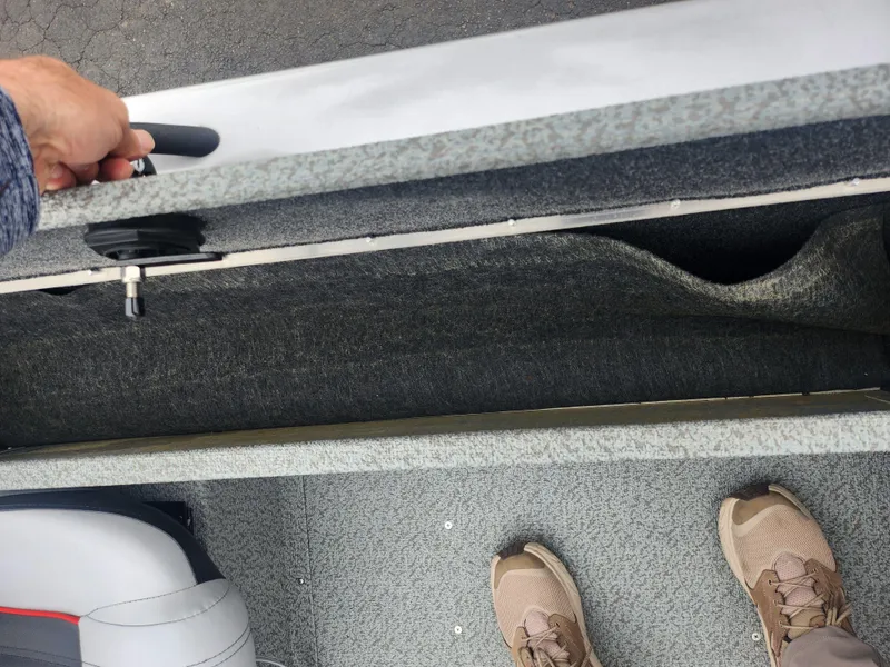 Slide: The Image of Interior view of a 2016 G3 Eagle 166 boat storage compartment with a person standing nearby. - 21