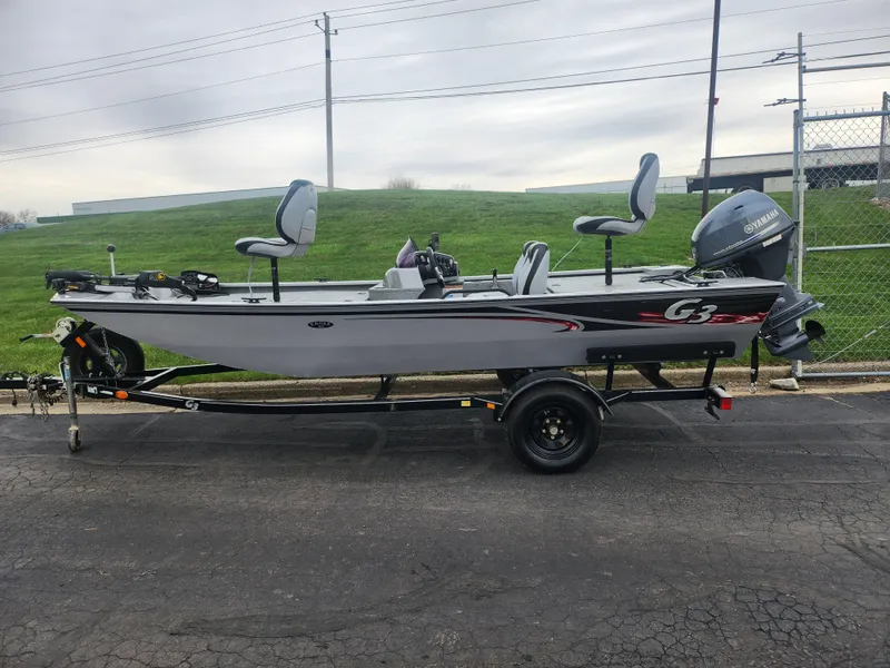 Slide: The Image of 2016 G3 Eagle 166 boat on trailer, featuring Yamaha outboard motor, parked outdoors. - 4