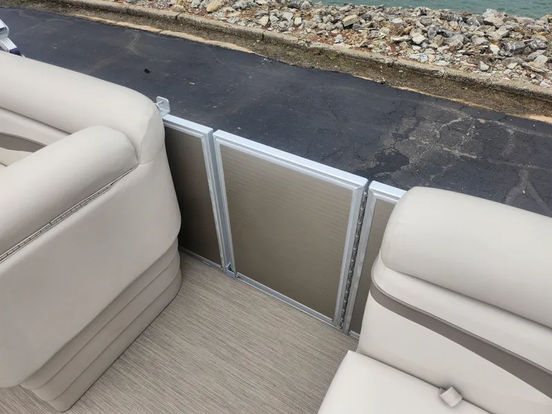 Slide: The Image of 2017 Bennington 20 SLMX pontoon boat interior with beige seating and railing. - 10