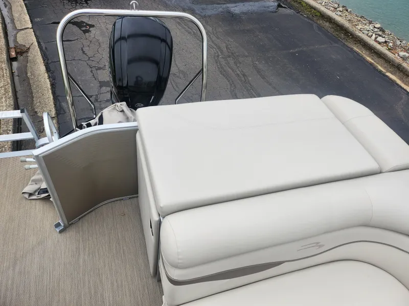 Slide: The Image of 2017 Bennington 20 SLMX pontoon boat with beige seating and outboard motor. - 14