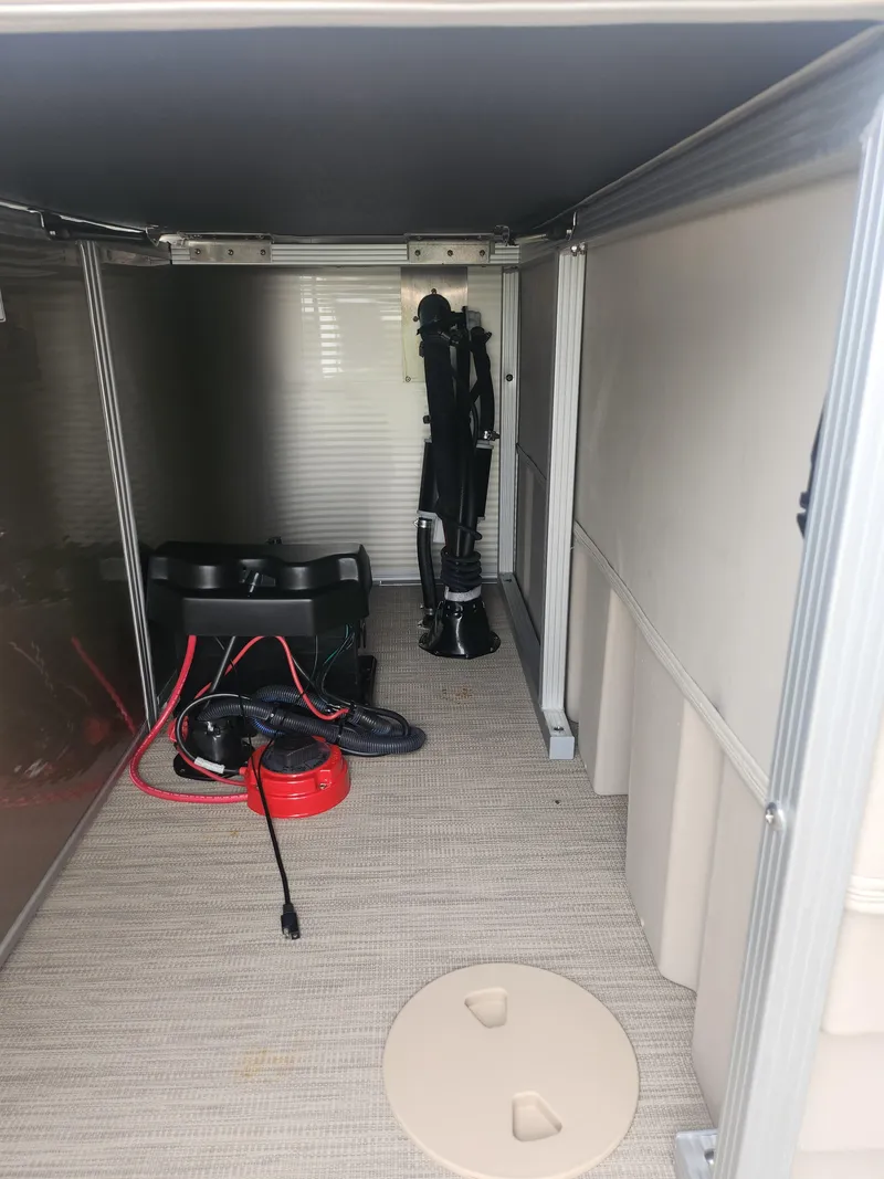 Slide: The Image of Interior storage compartment of a 2017 Bennington 20 SLMX boat with equipment and cables. - 15