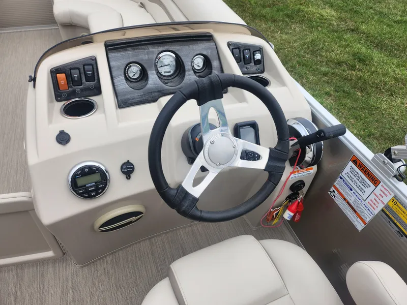 Slide: The Image of Steering console of a 2017 Bennington 20 SLMX pontoon boat with gauges and controls. - 19