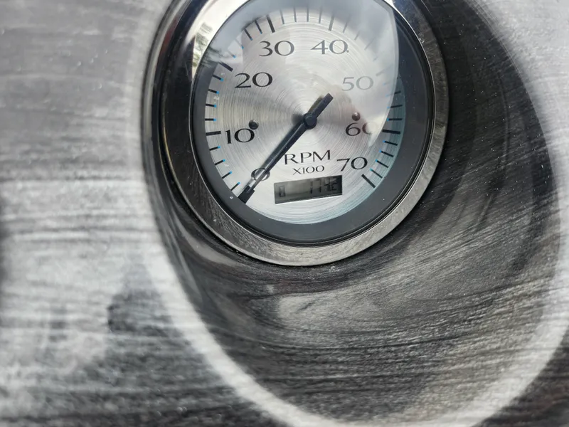 Slide: The Image of Close-up of a 2017 Bennington 20 SLMX RPM gauge, displaying up to 70 x100 RPM. - 20