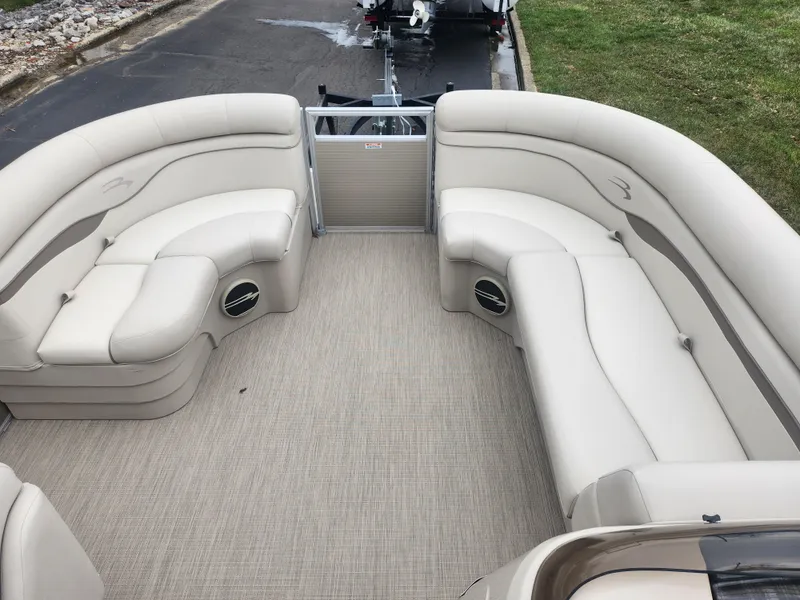 Slide: The Image of 2017 Bennington 20 SLMX pontoon boat interior with beige seating and carpeted floor. - 21