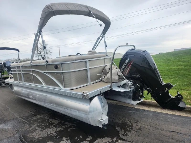 Slide: The Image of 2017 Bennington 20 SLMX pontoon boat with Mercury outboard motor on a paved surface. - 3