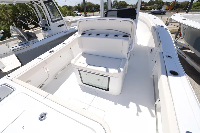 Slide: The Image of 2025 Sea Hunt Gamefish 27 boat interior with coffin box, white seating, and rod holders. - 11