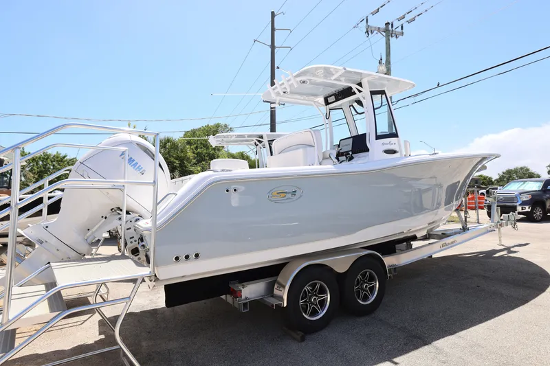 Slide: The Image of 2025 Sea Hunt Gamefish 27 with Coffin Box on trailer, featuring dual engines. - 14