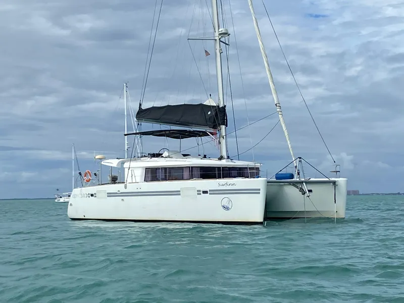 Slide: The Image of 2017 Lagoon 450 F catamaran sailing on calm waters under cloudy skies. - 0