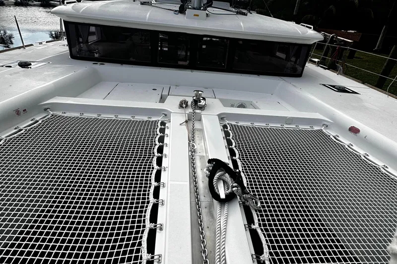 Slide: The Image of 2017 Lagoon 450 F catamaran deck with netting and anchor chain. - 11