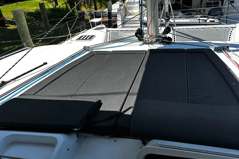 Slide: The Image of 2017 Lagoon 450 F catamaran deck with black sunbathing cushions. - 13