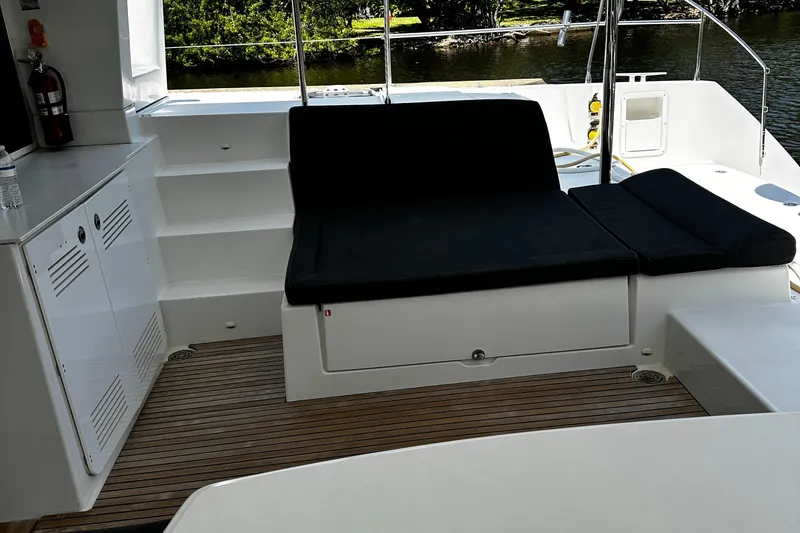 Slide: The Image of 2017 Lagoon 450 F yacht interior with black seating and wooden flooring. - 15