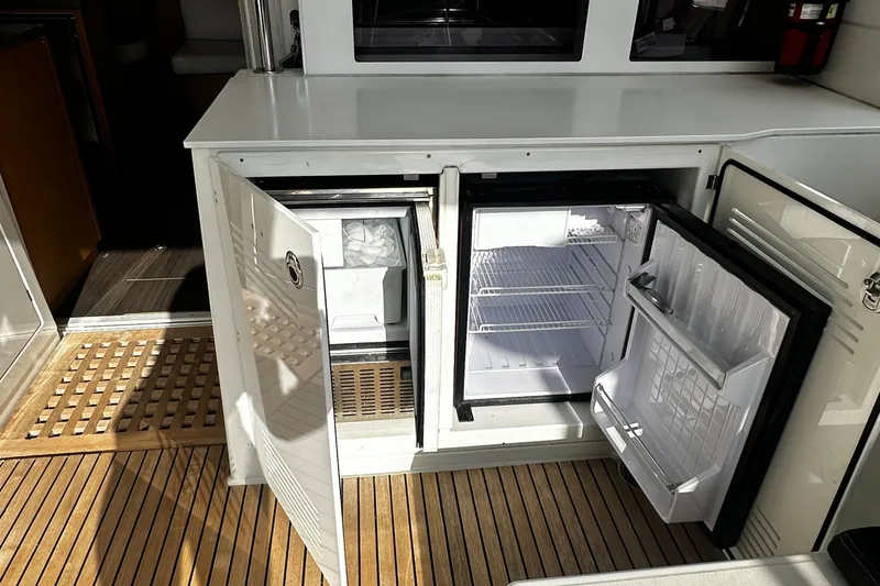Slide: The Image of Open fridge and freezer on 2017 Lagoon 450 F yacht with wooden deck. - 17