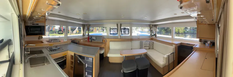 Slide: The Image of Interior of 2017 Lagoon 450 F catamaran, featuring spacious seating and modern kitchen area. - 18