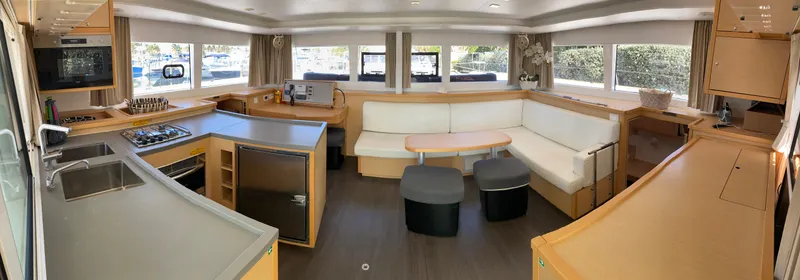 Slide: The Image of Spacious interior of 2017 Lagoon 450 F catamaran with modern kitchen and seating area. - 19