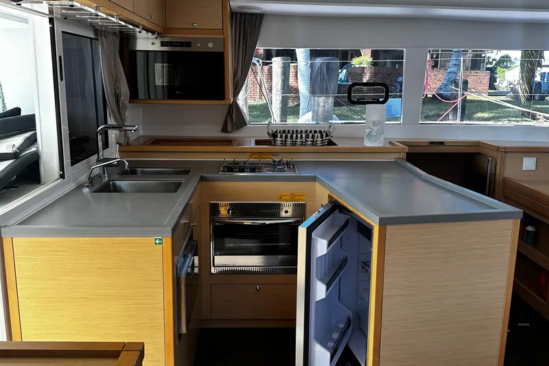 Slide: The Image of Modern kitchen interior of 2017 Lagoon 450 F catamaran with appliances and ample counter space. - 21