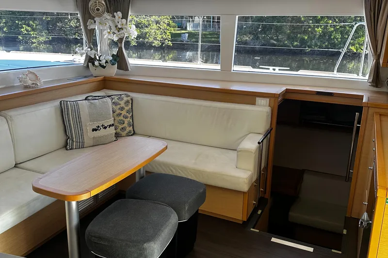Slide: The Image of Interior of 2017 Lagoon 450 F catamaran with cozy seating and elegant decor. - 25