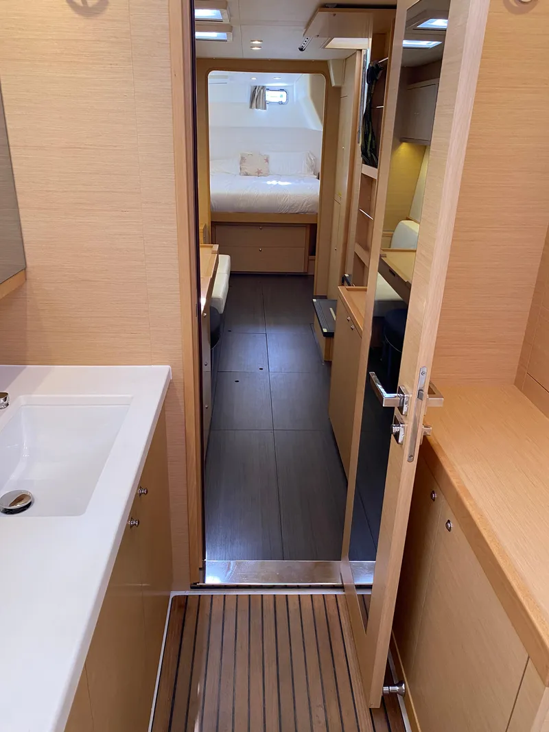Slide: The Image of Interior of 2017 Lagoon 450 F catamaran, featuring modern bathroom and cozy cabin. - 29