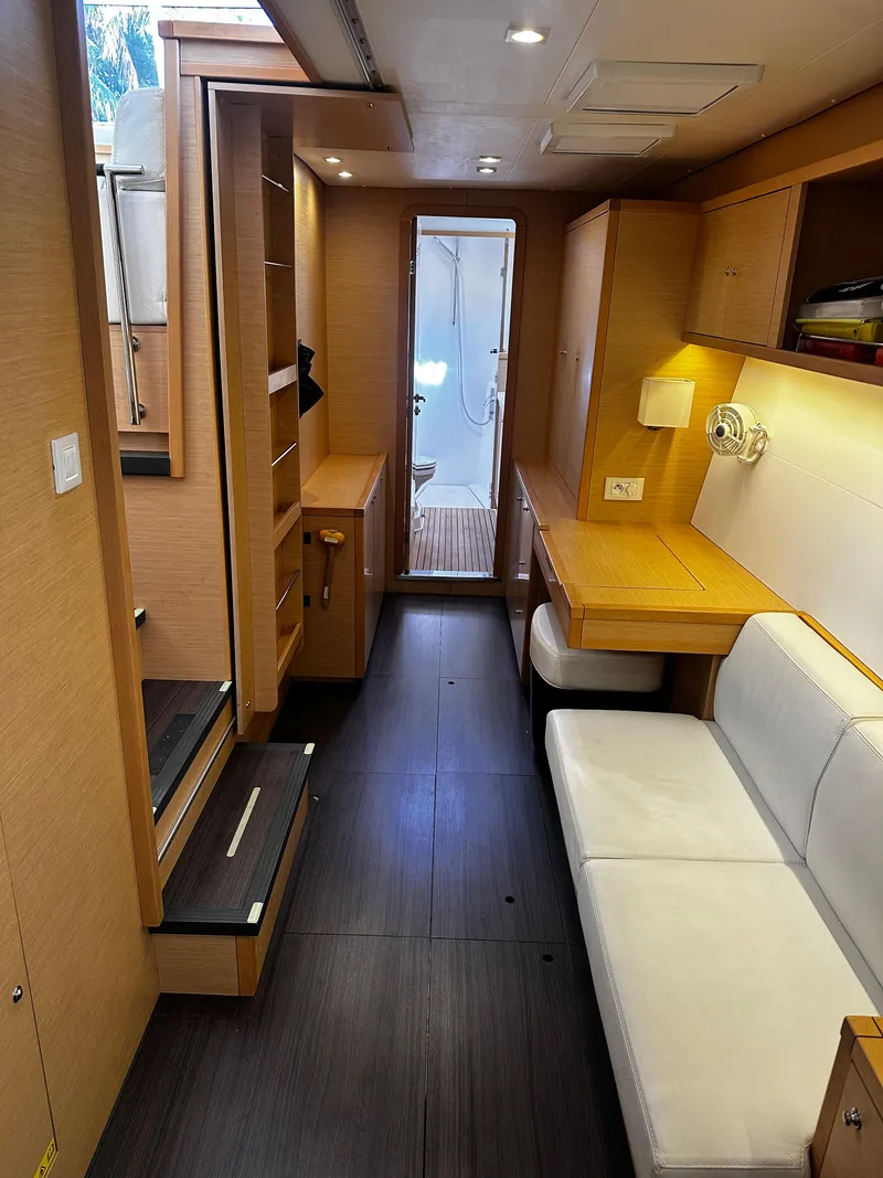 Slide: The Image of Interior of 2017 Lagoon 450 F catamaran, featuring modern wood finishes and cozy seating. - 33