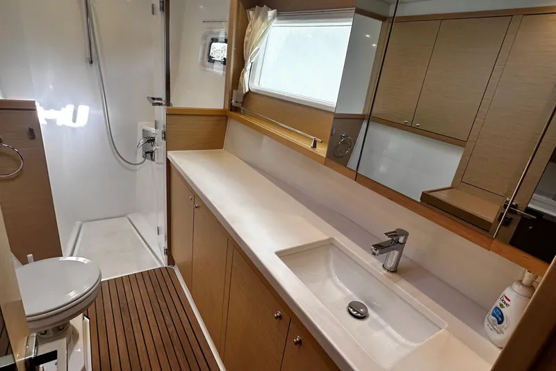 Slide: The Image of Modern bathroom in 2017 Lagoon 450 F yacht with shower, sink, and wooden flooring. - 36