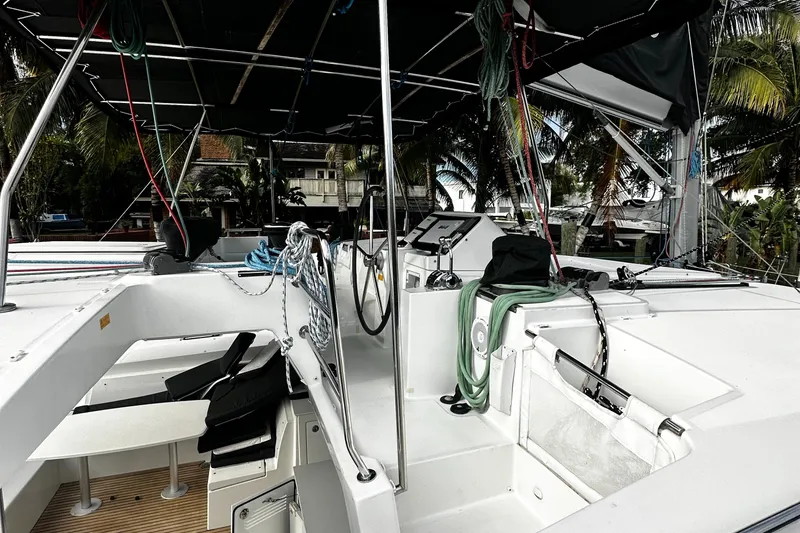 Slide: The Image of 2017 Lagoon 450 F catamaran cockpit with seating, helm, and tropical backdrop. - 46